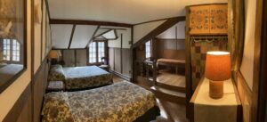 panoramic of room with beds and lamp